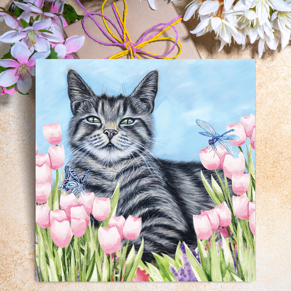 greeting card of a cat among pink tulips and flowers.