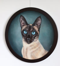 Framed artwork of a Siamese cat with blue eyes on a white wall.