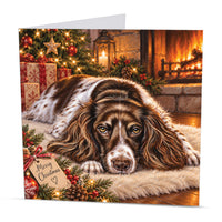 Square 15 x 15 cm Springer Spaniel Christmas card featuring original festive dog artwork by Irisha, printed on premium 350 gsm textured cardstock.