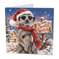 Square wildlife Christmas card featuring a festive meerkat in a snowy winter landscape with a cosy cottage and Christmas decorations