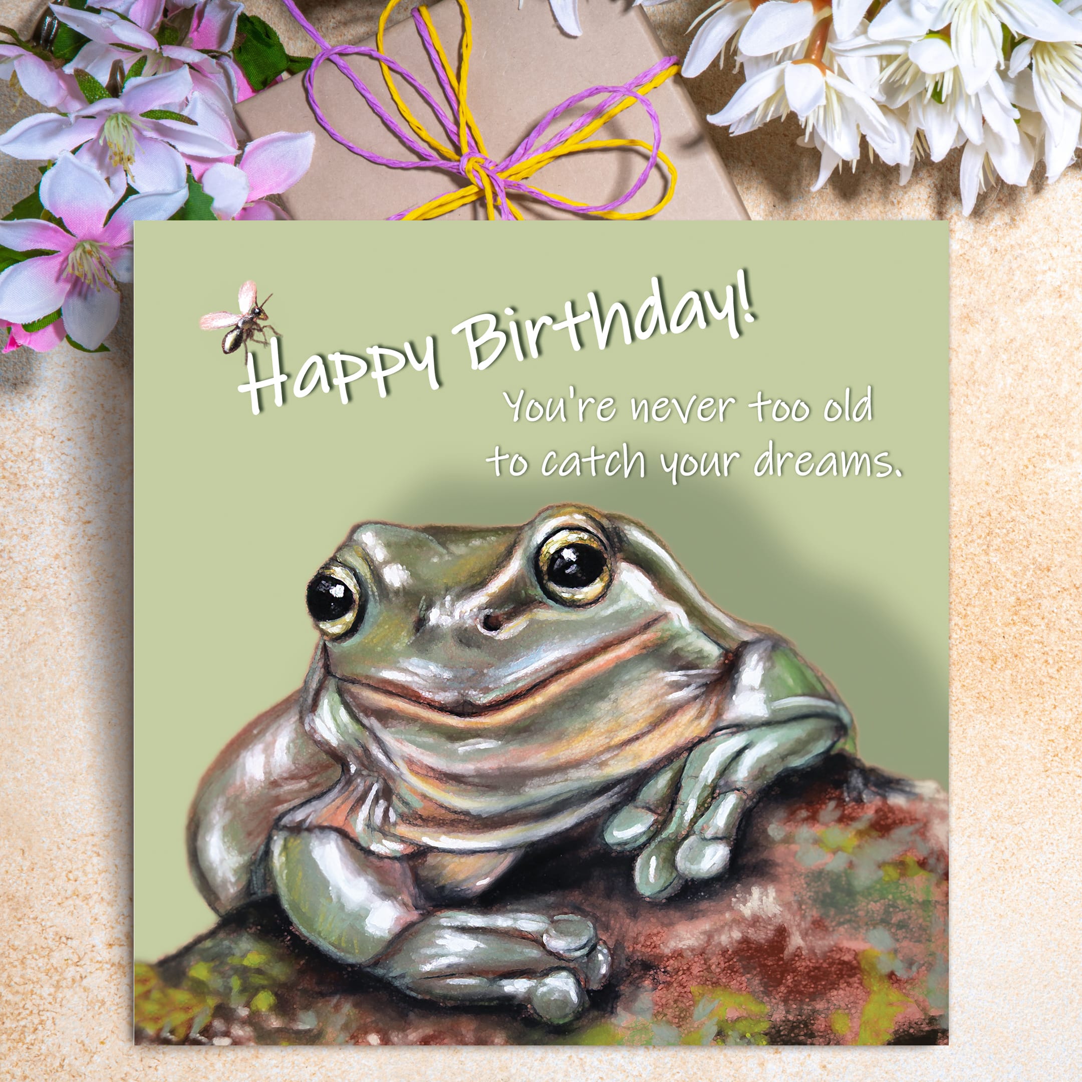 Funny frog birthday card featuring an illustrated frog with the caption “You’re never too old to catch your dreams.”