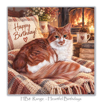 Cosy cat birthday greeting card with a long-haired ginger and white cat, warm fireplace, tartan blankets, vintage books and candlelit lantern.