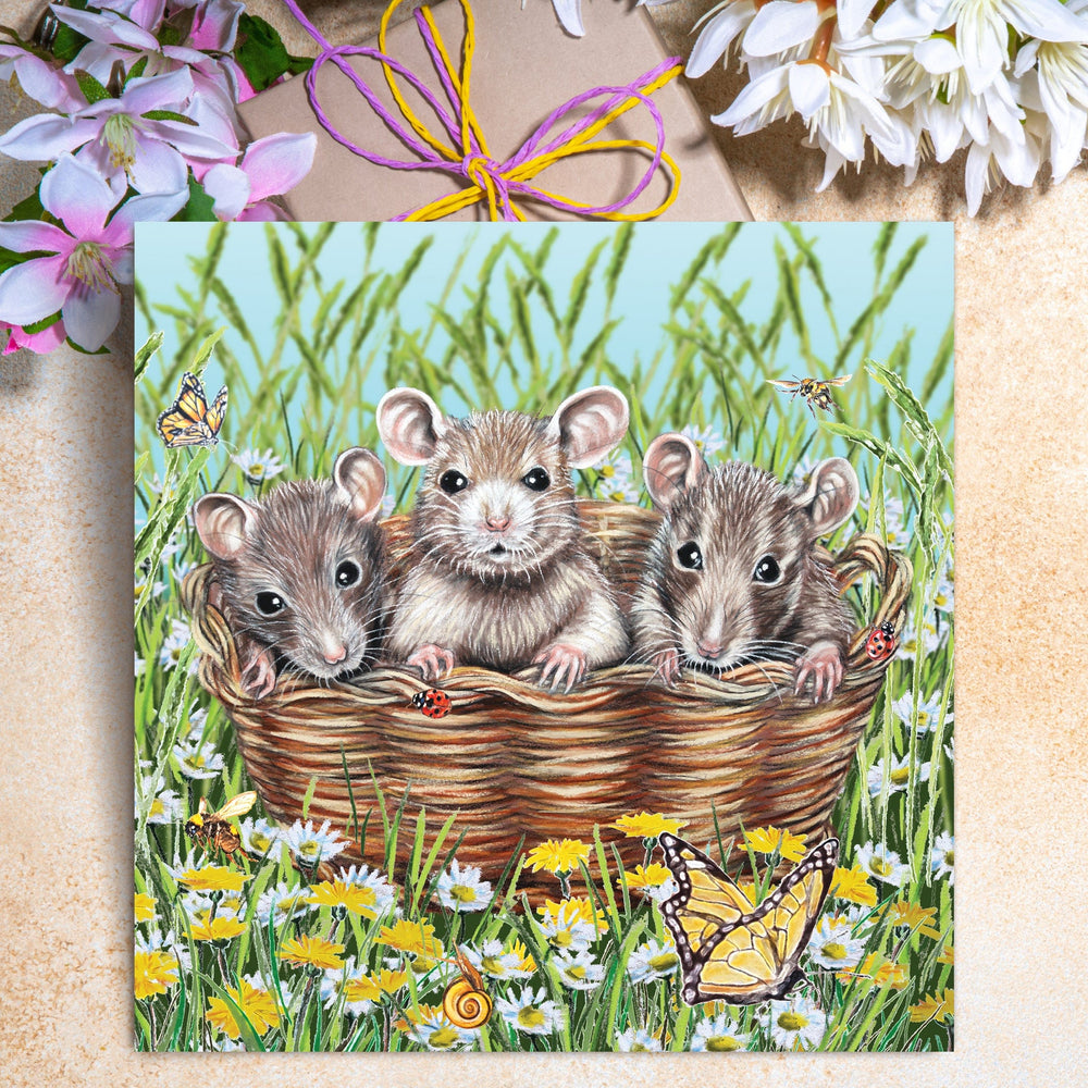 Cute mice greeting card featuring three little mice sitting in a basket surrounded by daisies, dandelions, butterflies, and bees.