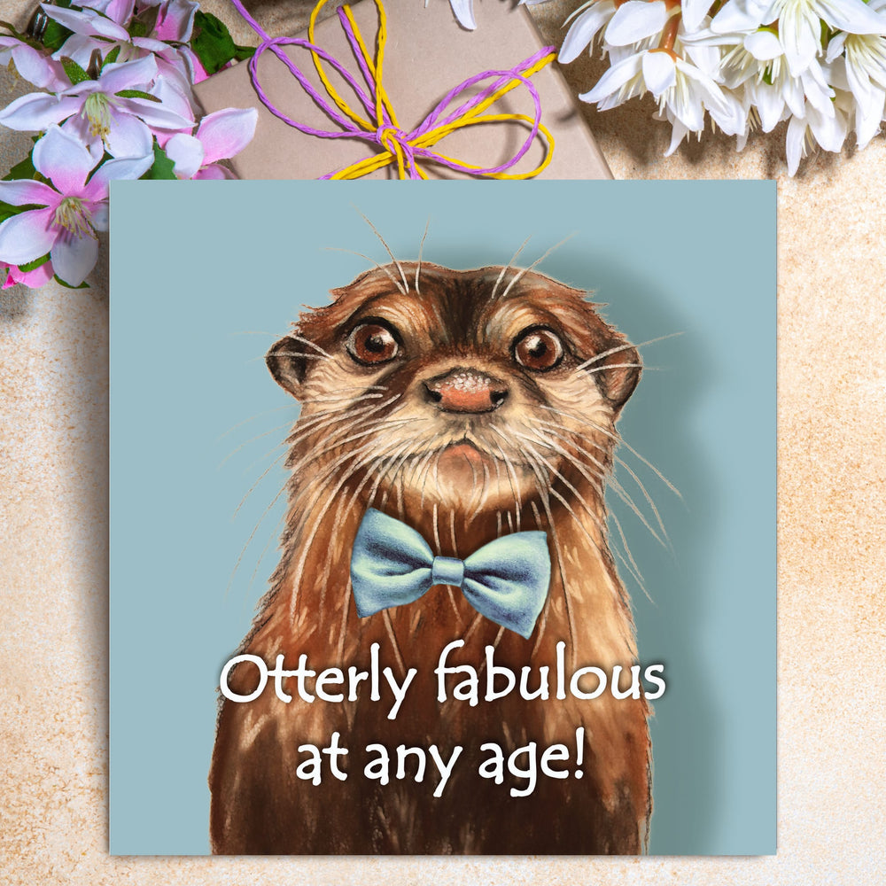 Funny otter birthday card featuring an illustrated otter in a blue bow tie with the caption “Otterly fabulous at any age!”