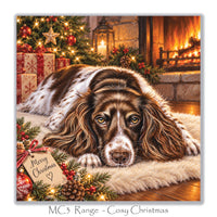 Cosy English Springer Spaniel Christmas greeting card with a brown and white dog, decorated Christmas tree, festive presents and warm fireside setting.